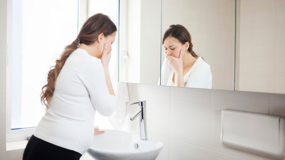 Woman dealing with excess saliva during pregnancy