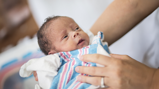 Why Newborn Vision Is Blurry but Highly Sensitive to Faces