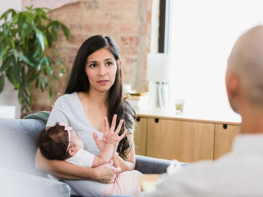 WOMAN WITH POSTPARTUM  DEPRESSION TALKING TO HER DOCTOR