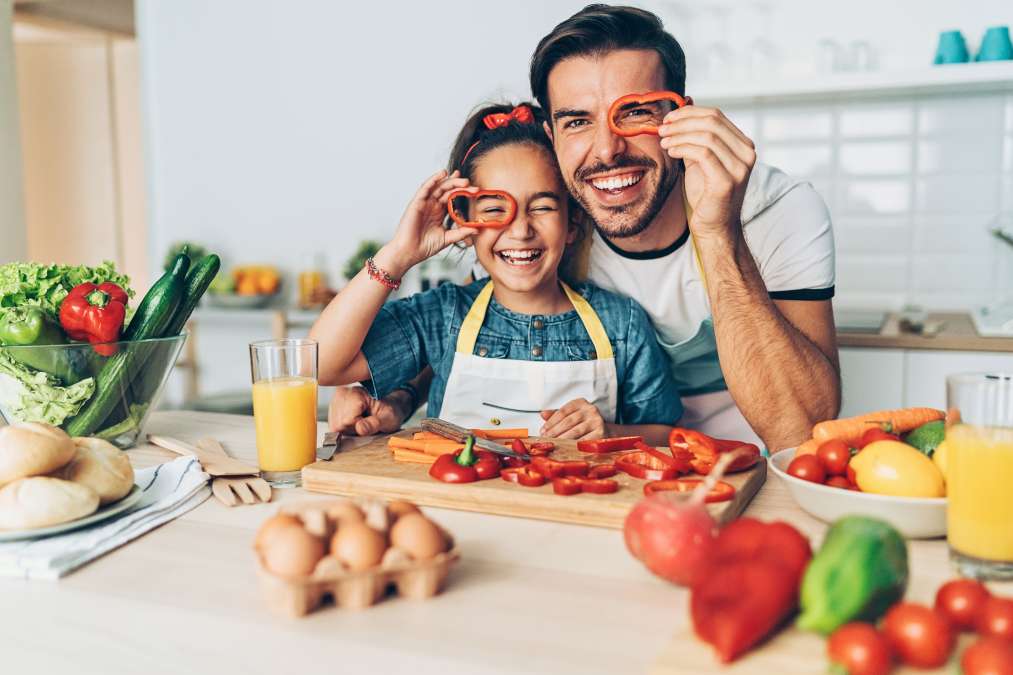 Father and daughter having fun cooking together