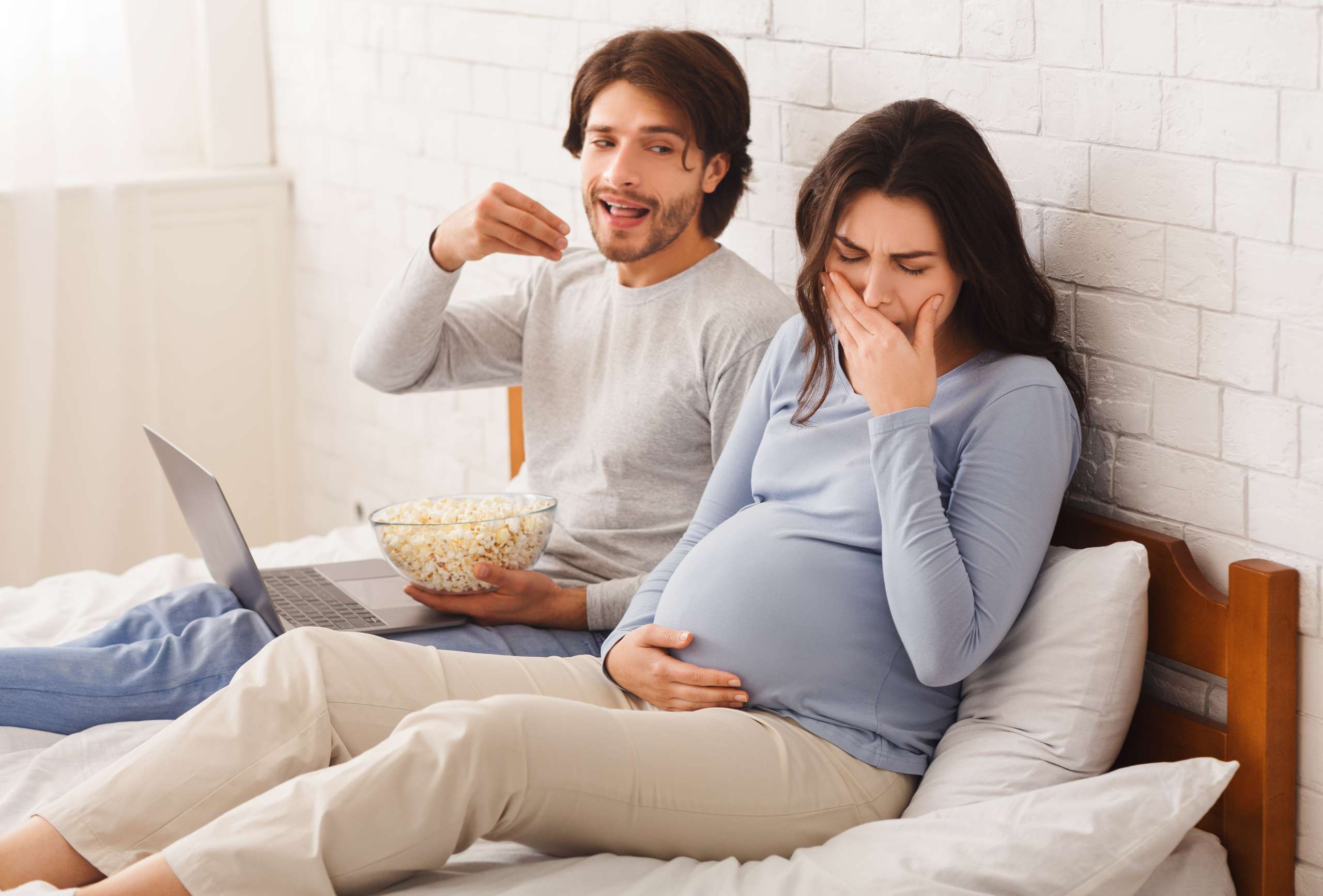 Pregnant woman feeling sick because of smell of popcorn- Maternal Hyperemesis Gravidarum