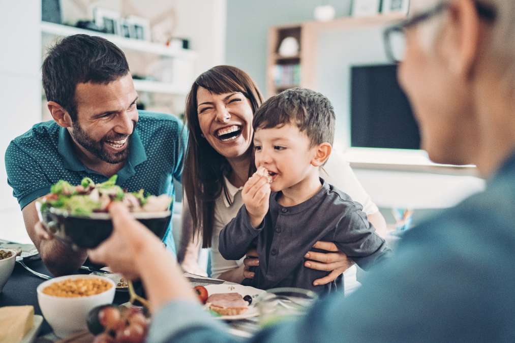 Family laughing and eating together- Positive Relationship with Food
