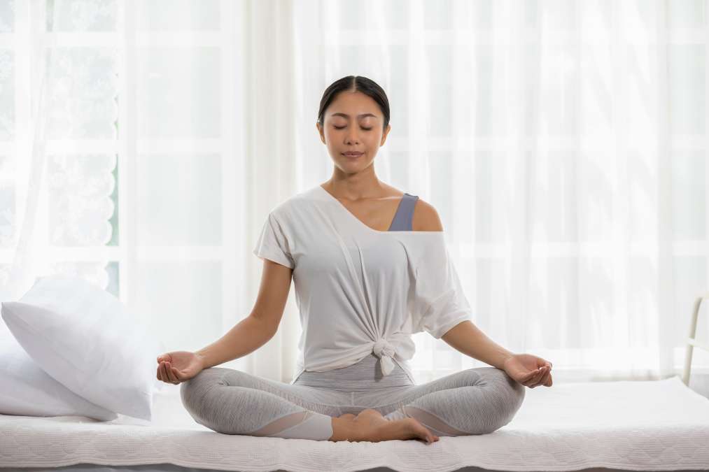 A woman practicing Yoga- Physical Activity In Combating Postpartum Depression