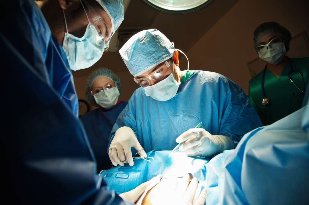 Surgeons performing C-Section in operating room- Birthing Choices