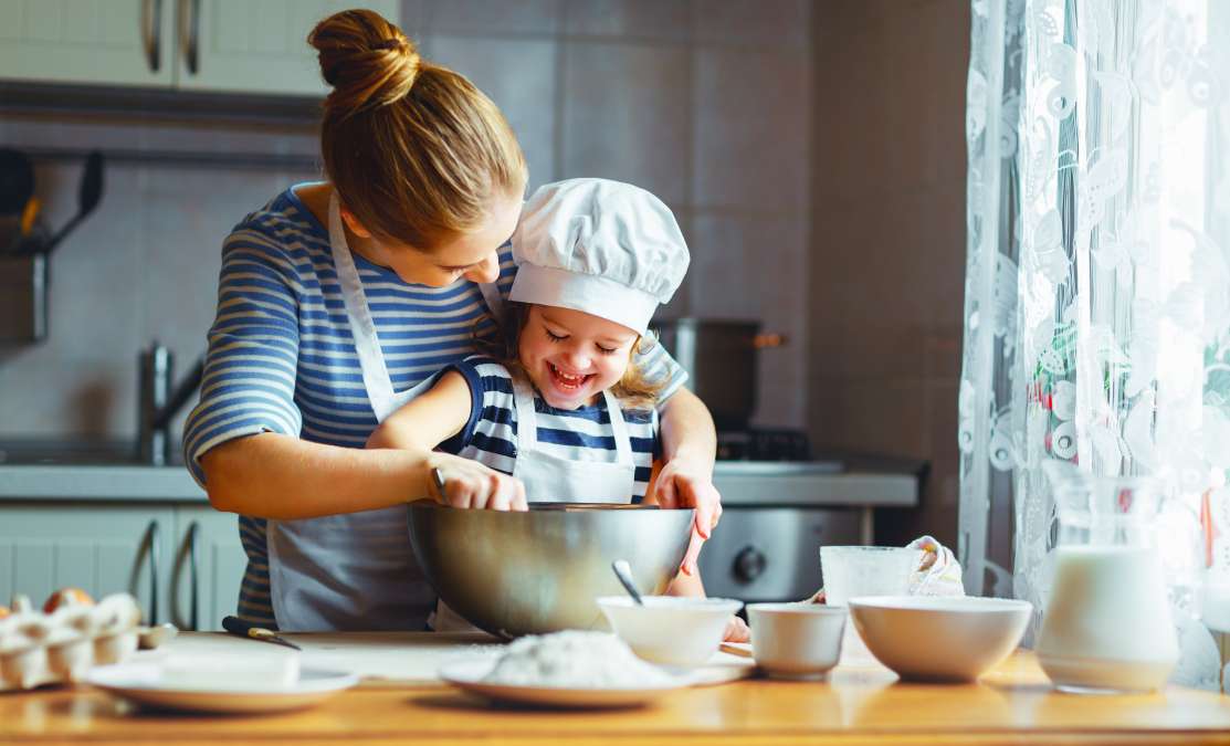 Mother and child preparing food