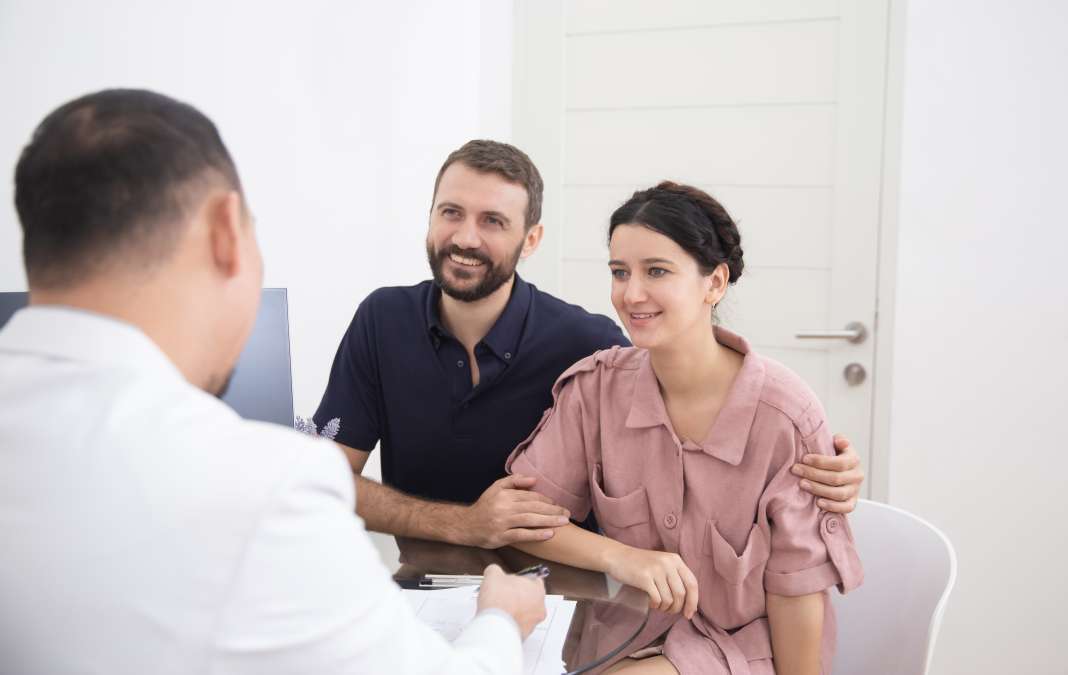 Doctor consulting young couple
