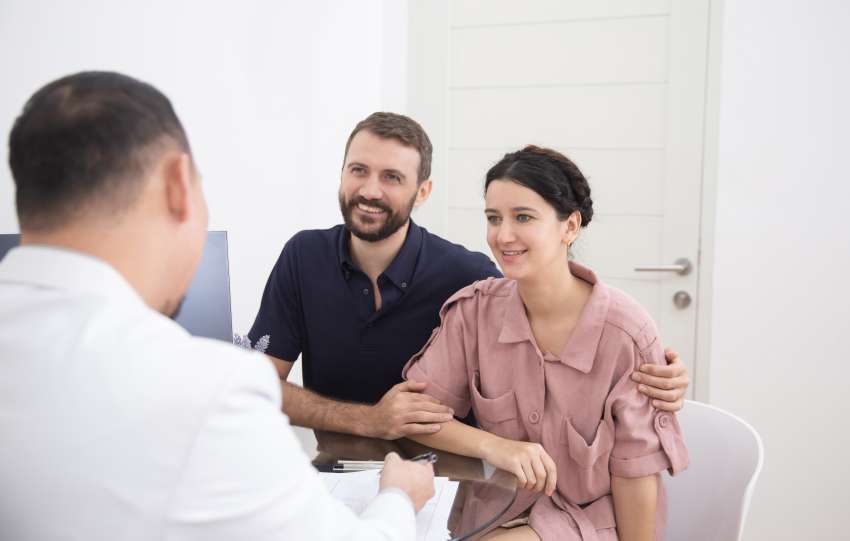 Doctor consulting young couple