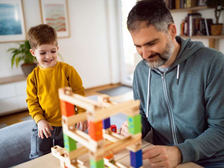 child and father building a model