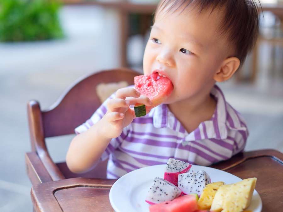 CHILD EATING DIFFERENT FRUITS