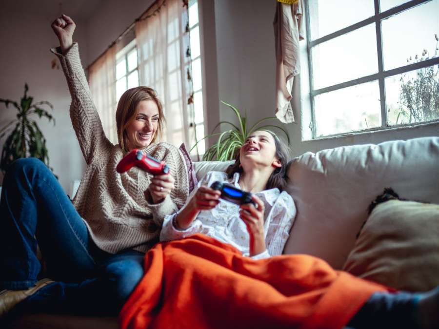 child playing video game with mother