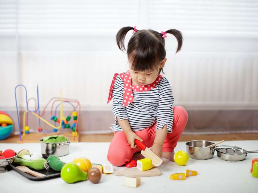 Child playing with kitchen utensils