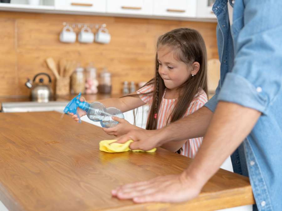 child cleaning table