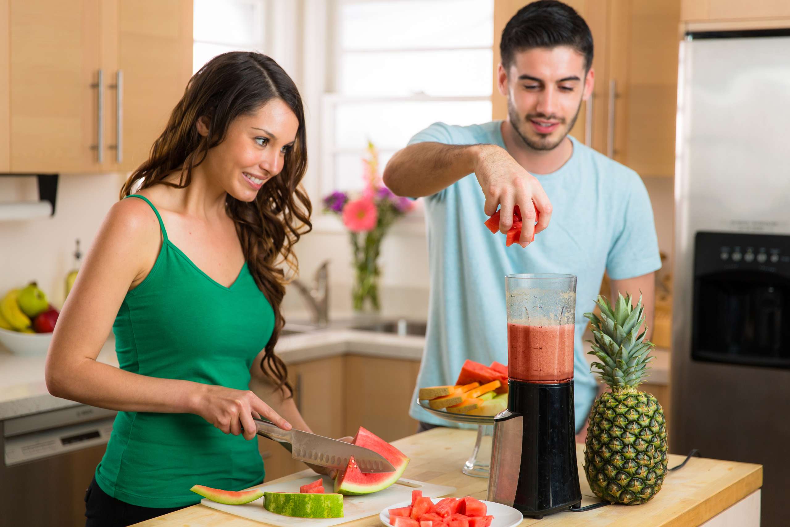 COUPLE preparing healthy juice