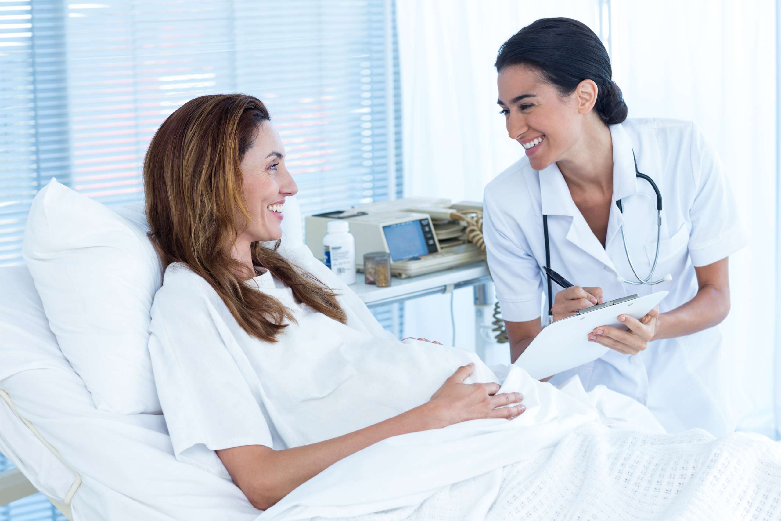 PREGNANT WOMAN DISCUSSING THE BABY'S MOVEMENT WITH HER DOCTOR- Vascular Changes In Pregnancy