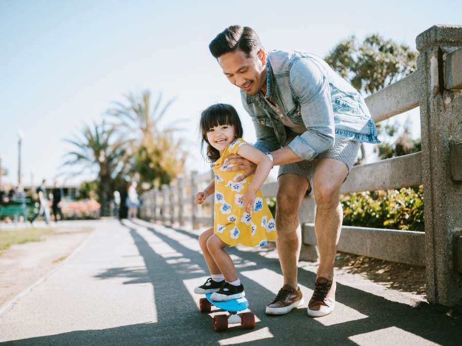 father and daughter skateboarding