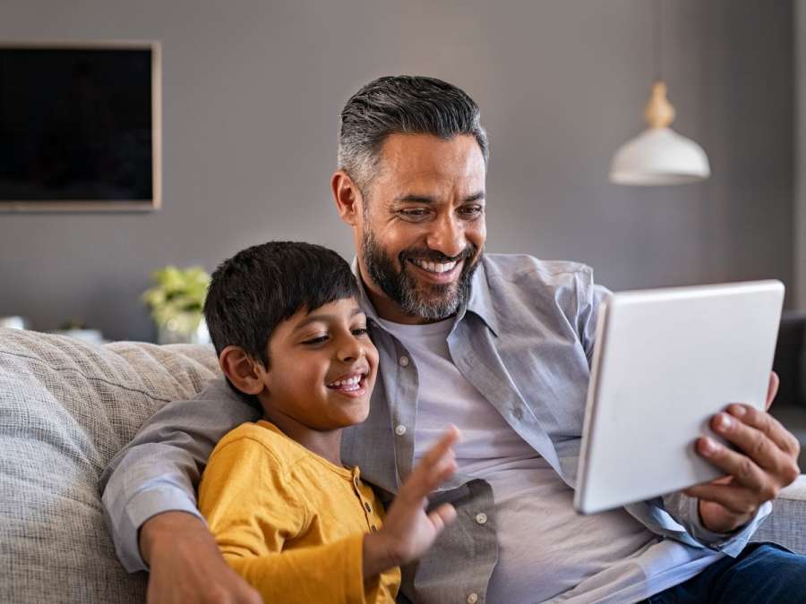 father and son looking at laptop