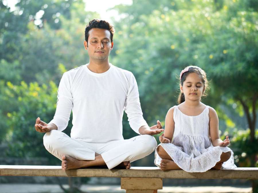 father and daughter meditating