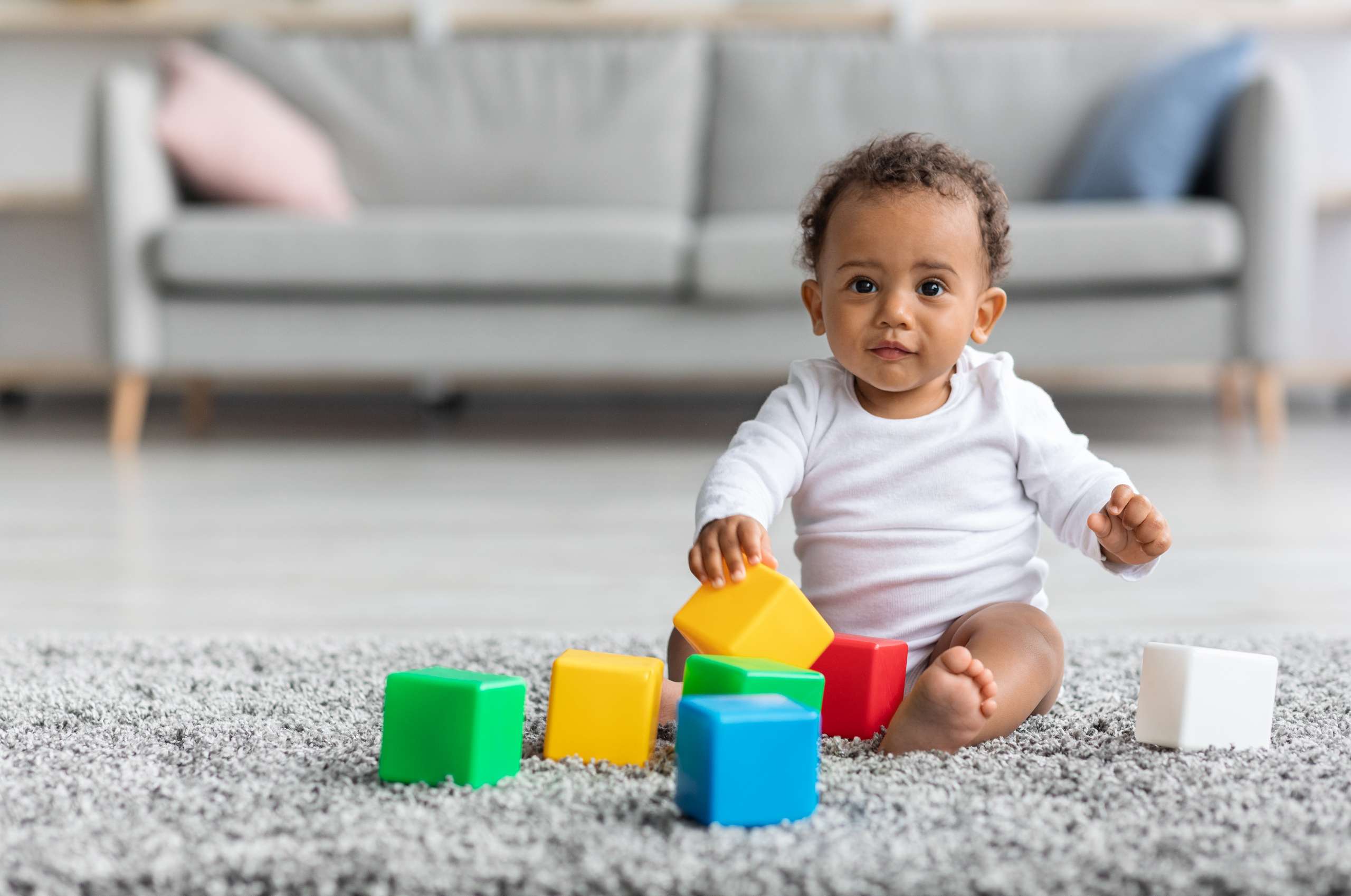 CHILD PLAYING WITH TOYS- Muscle Development In Toddlers