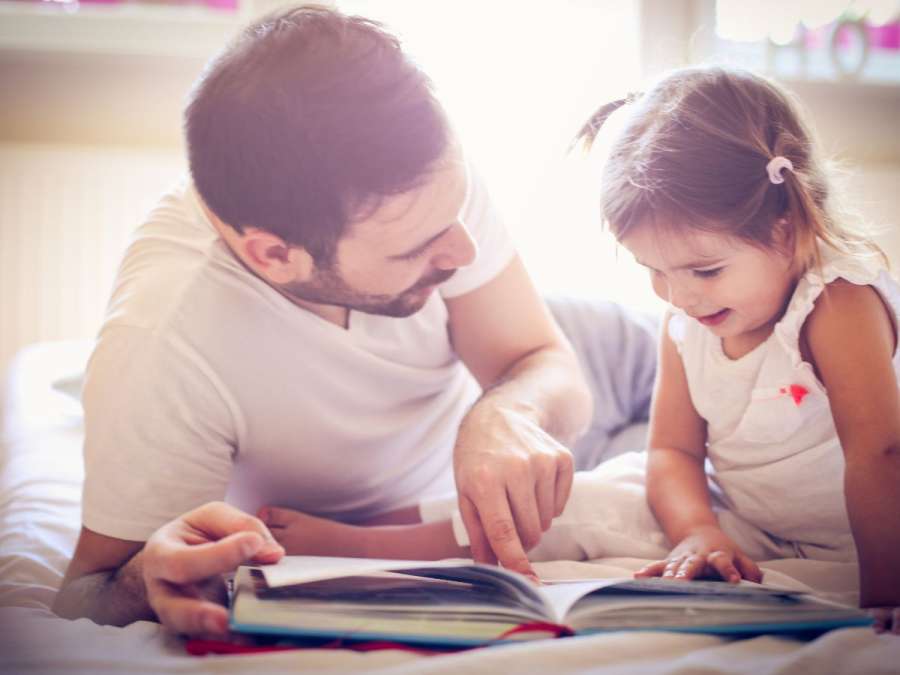 Father reading aloud to child