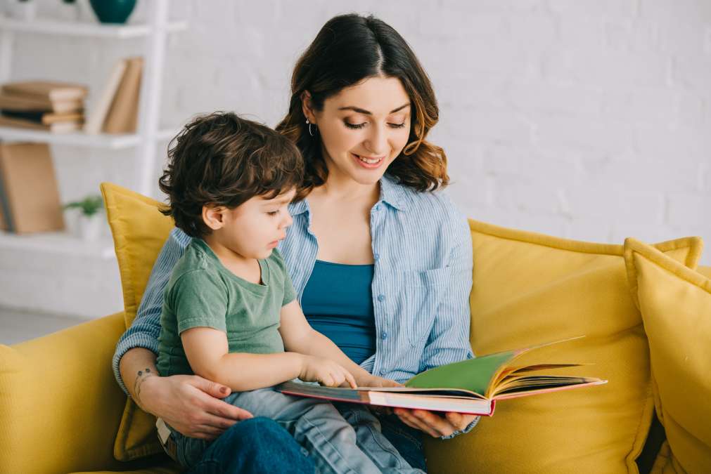 Mother helping toddler studying