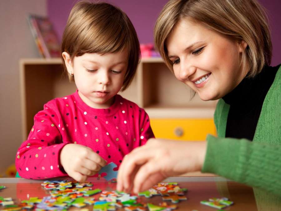 Child and mother arranging puzzles