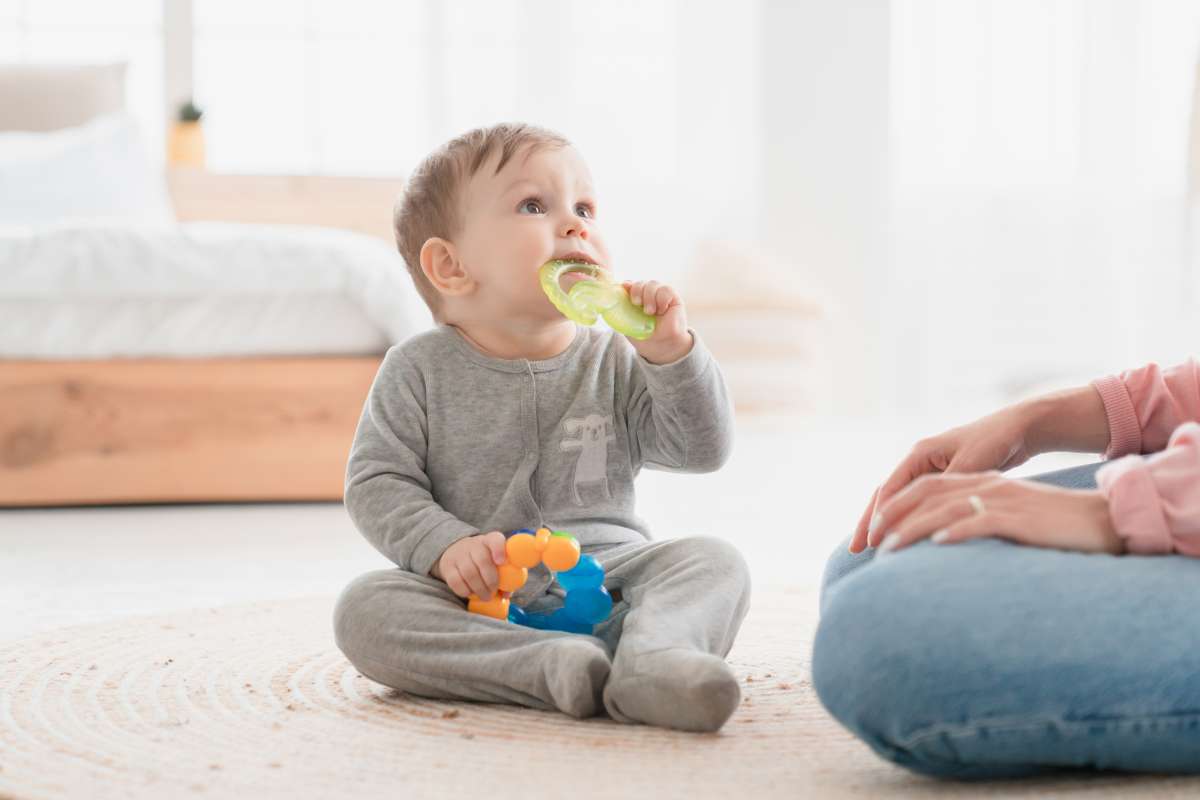 child playing with teething toy- Baby's Interaction With Toys