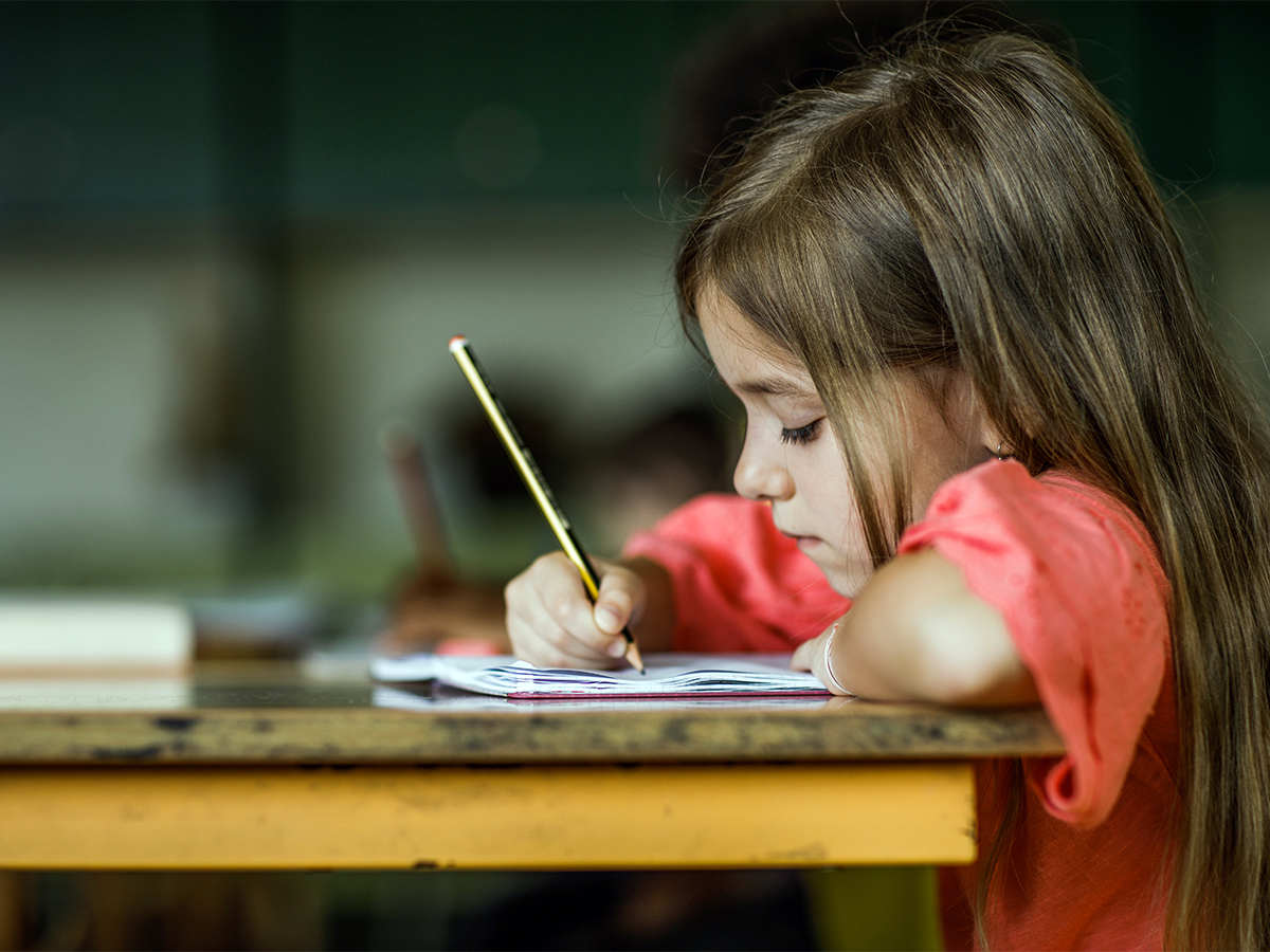 child writing on a journal-  Different Learning Styles In Children