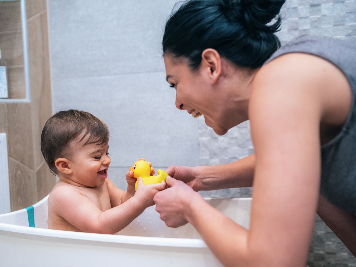 child playing with toy while bathing-Object Permanence For Babies