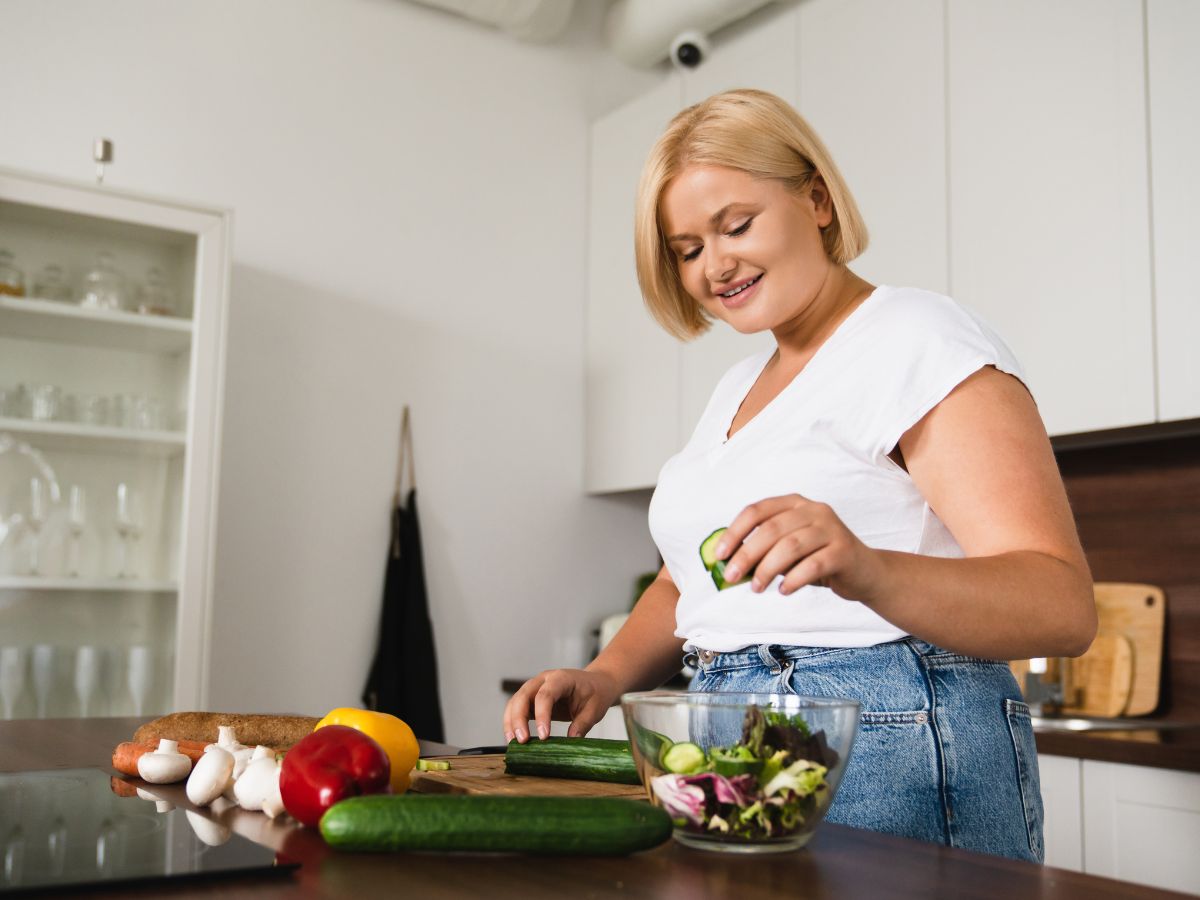 overweight woman cooking healthy meal- Fertility For Overweight Women