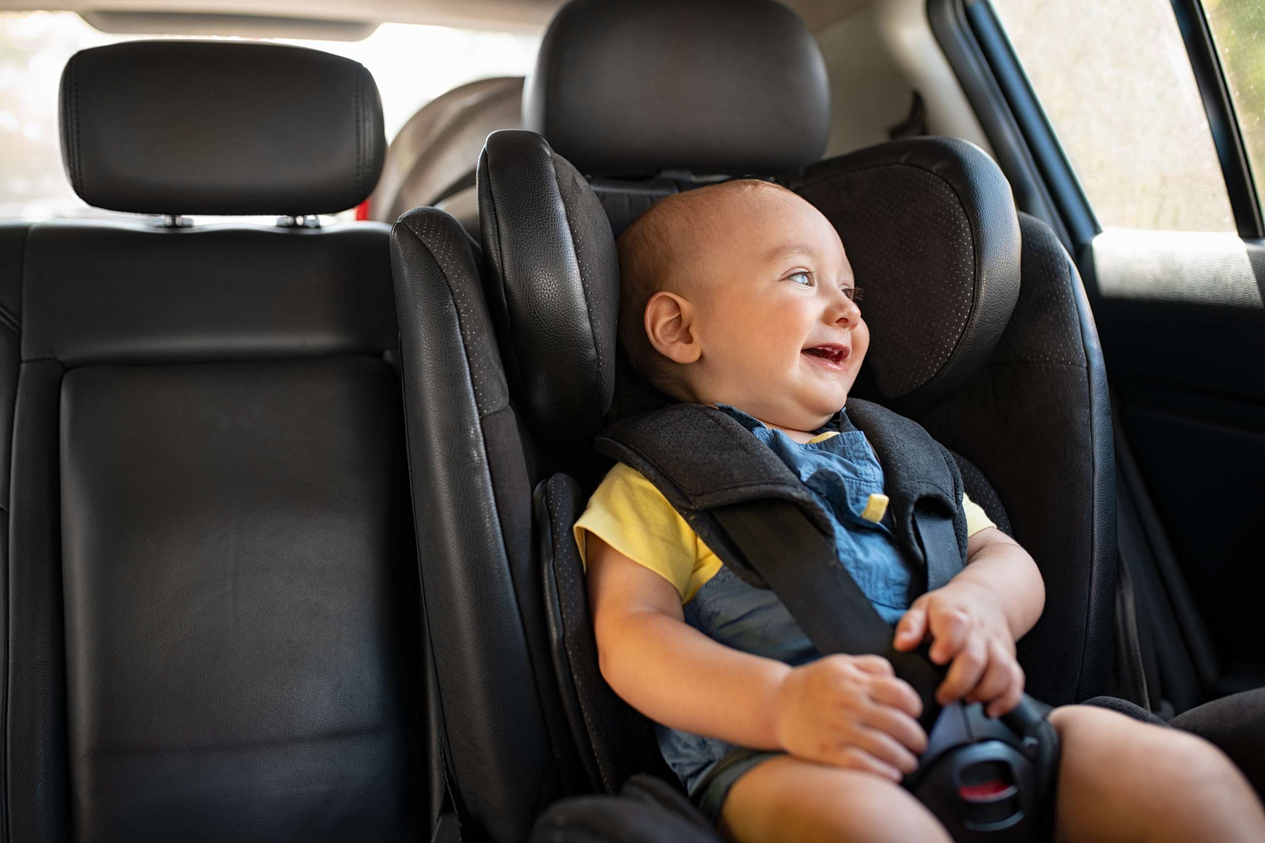 Toddler sitting in car during road trip