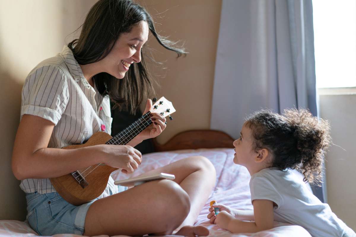 mother playing rhyme on a ukulele
