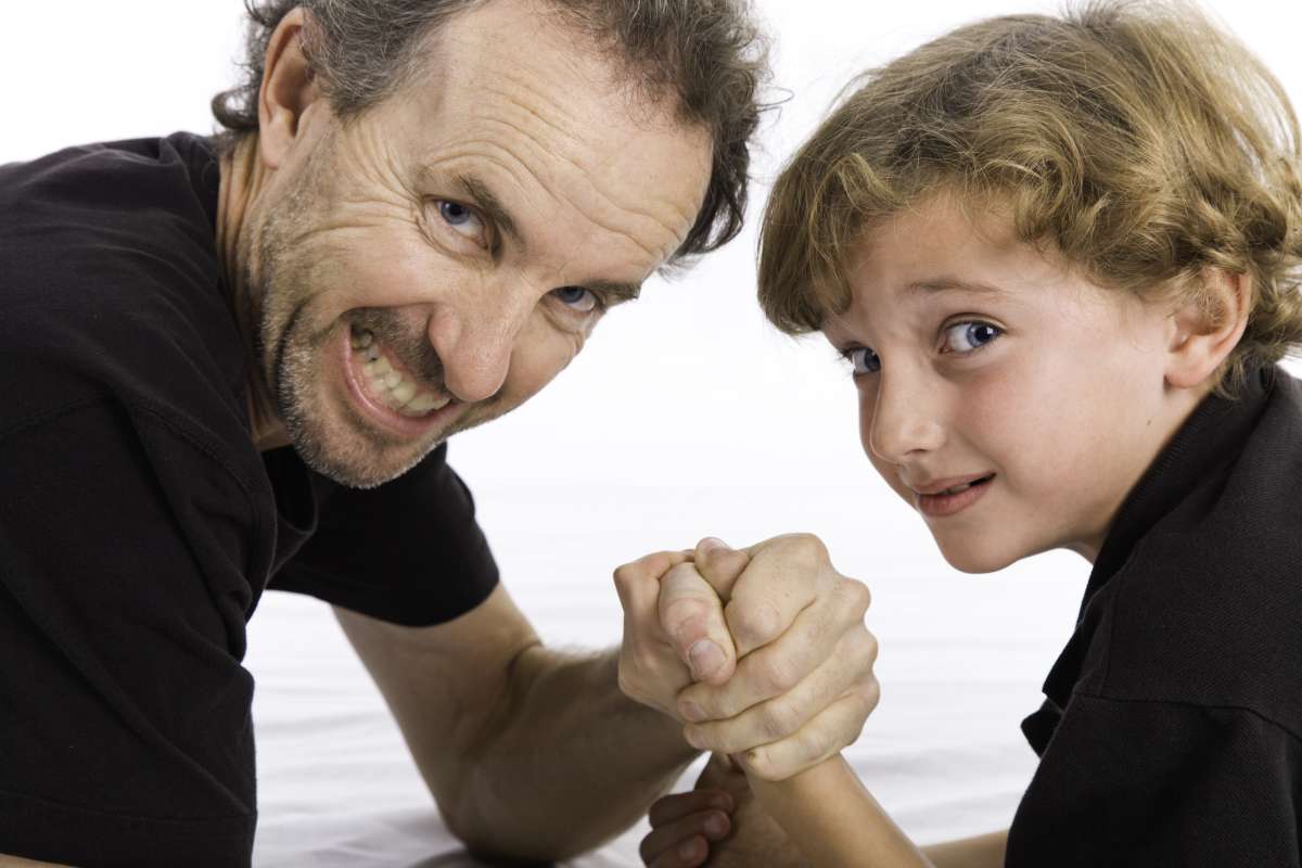 Father and child arm wrestling