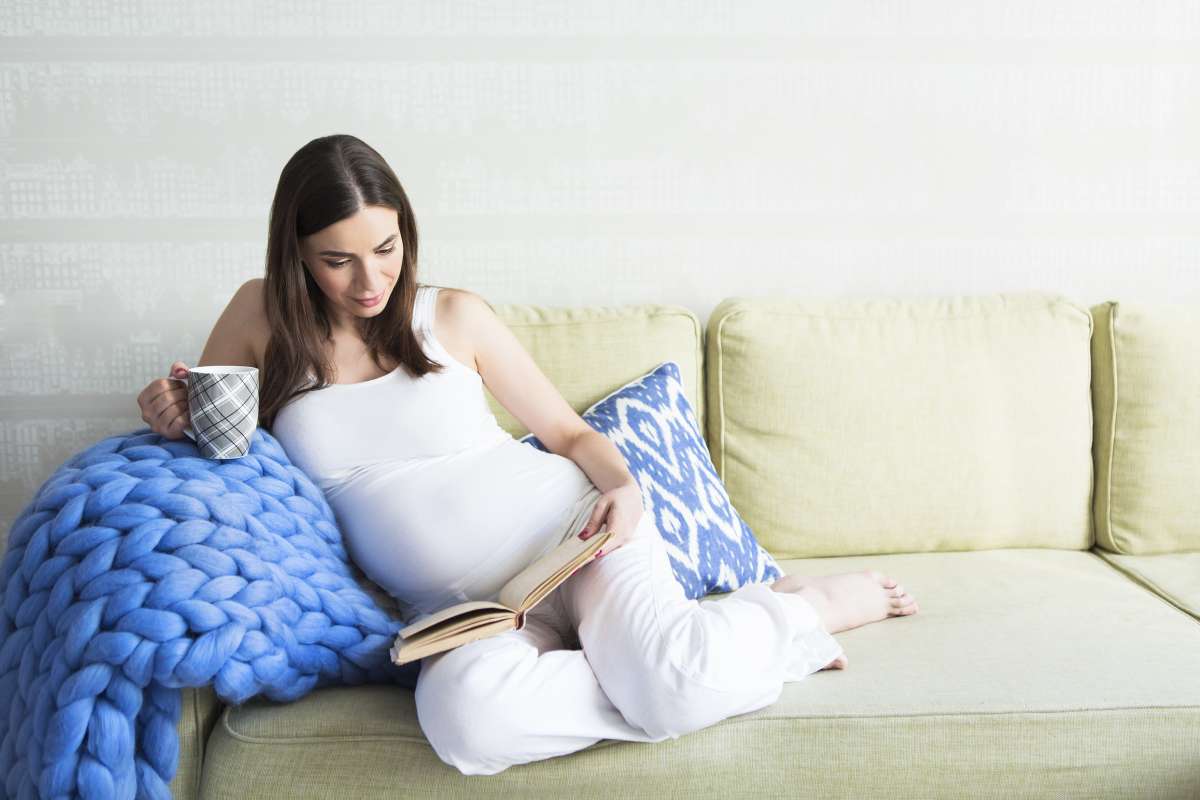 pregnant woman reading to baby
