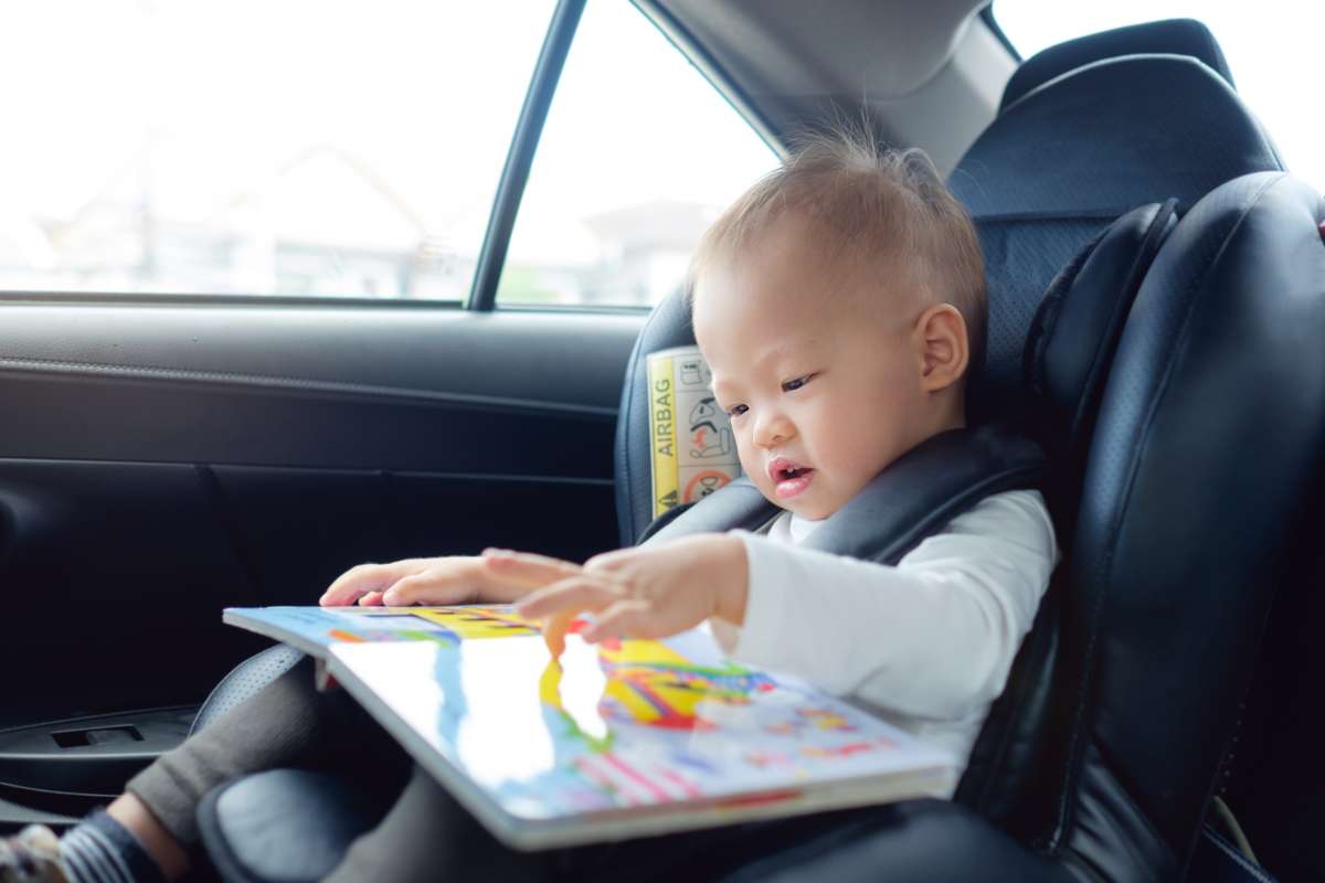 toddler sitting in car