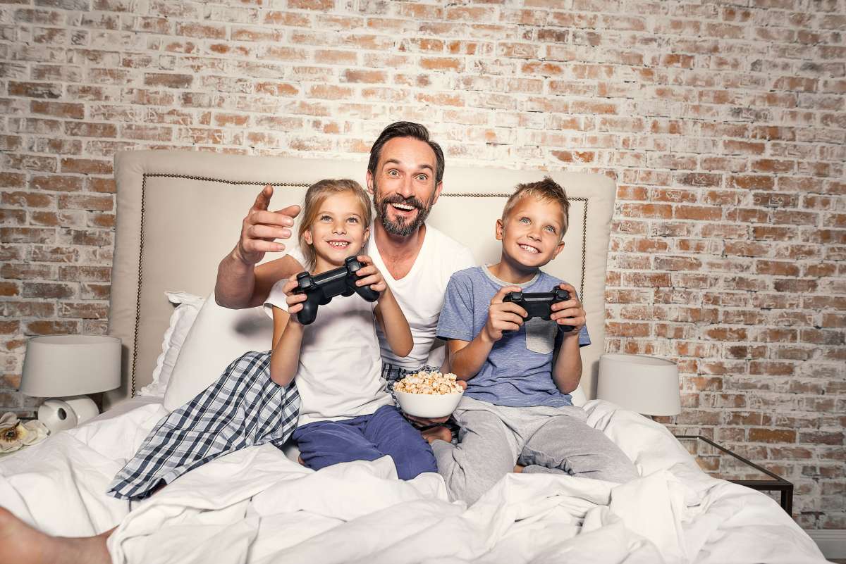 child and father playing video games