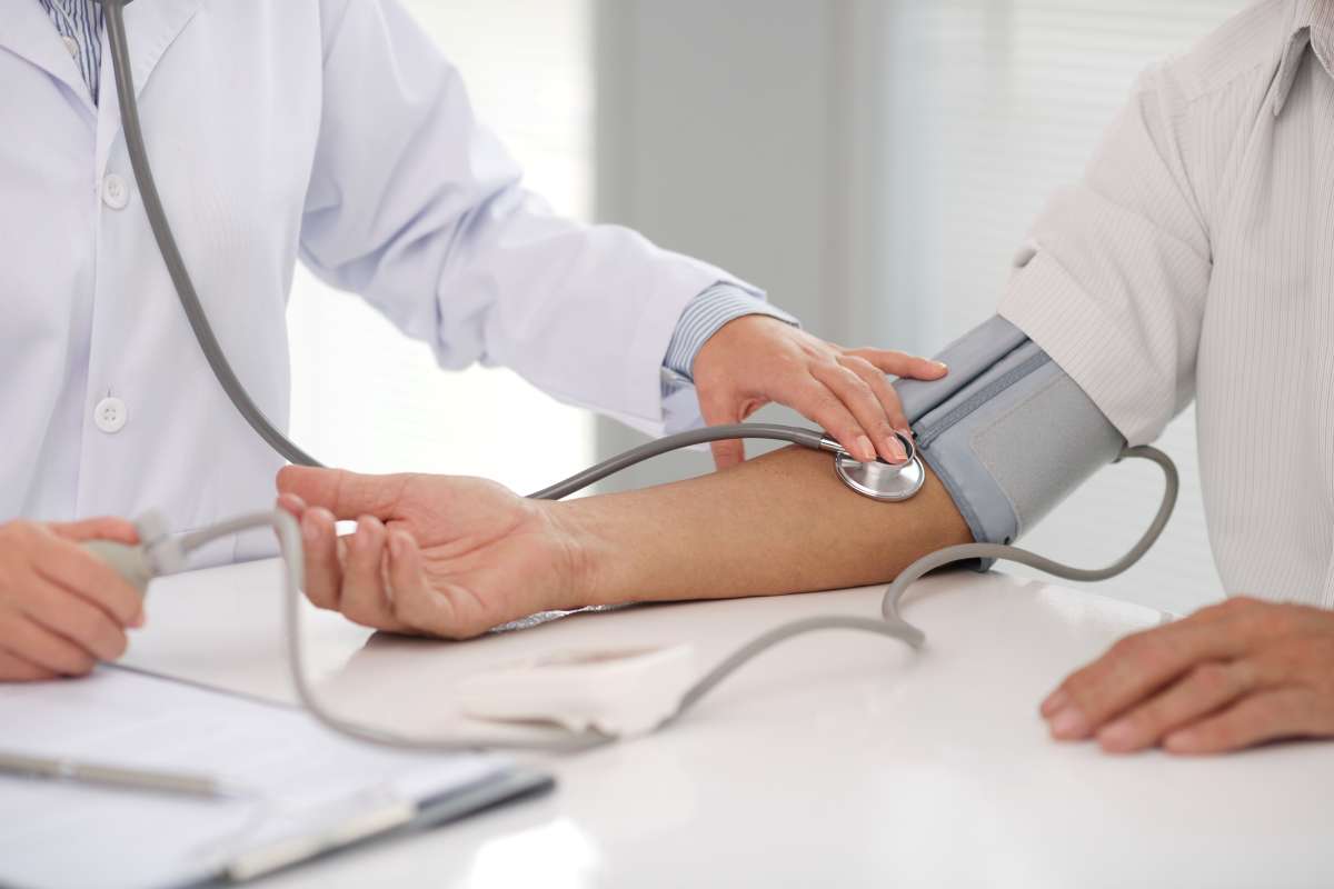 Doctor checking patients blood pressure 