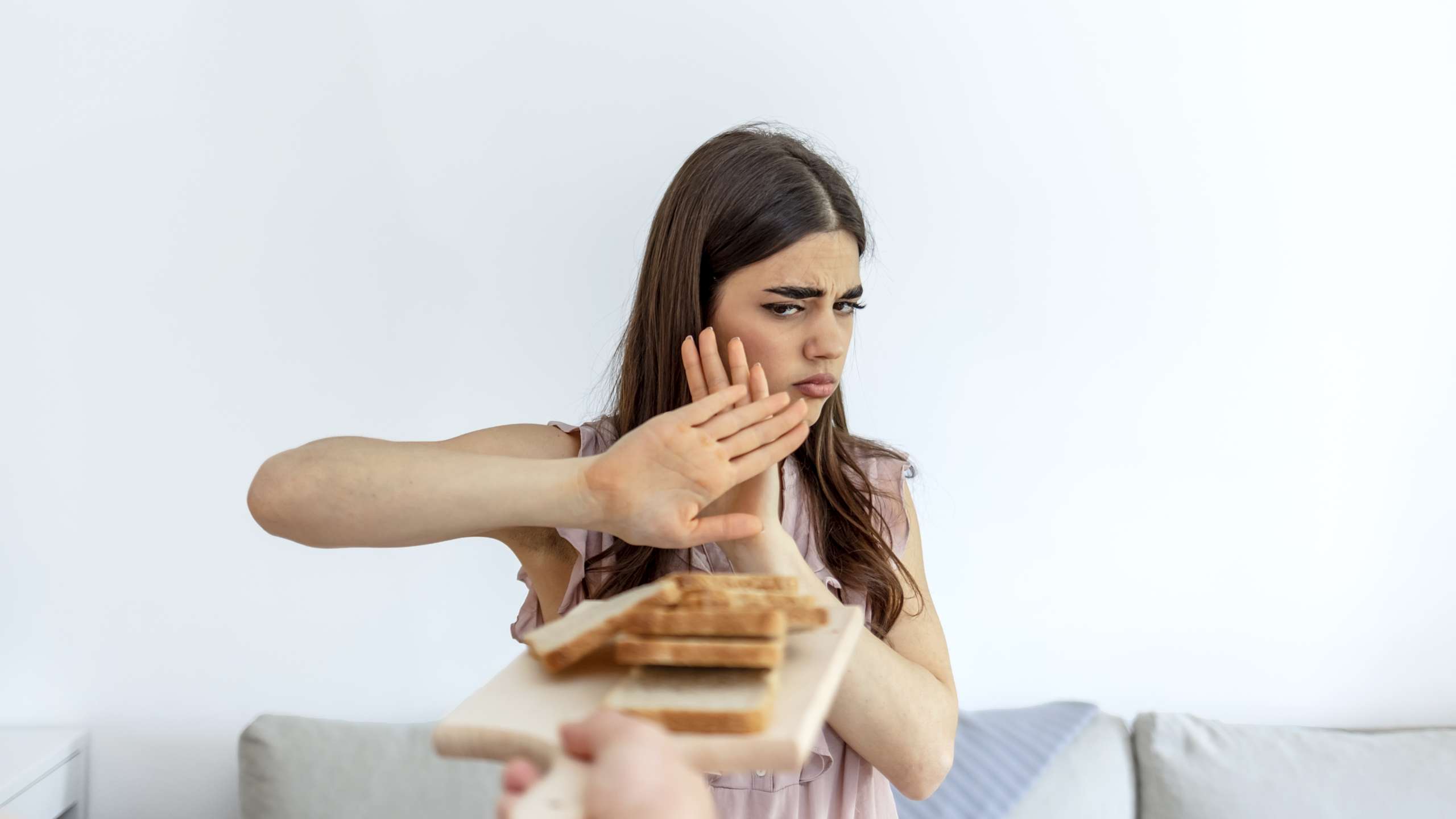 Woman refusing to eat white bread- Gluten-Free Diets And Fertility