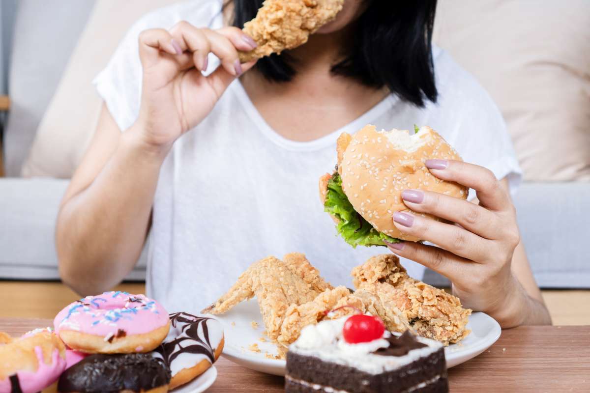 woman eating junk food- Pre-Pregnancy Cravings