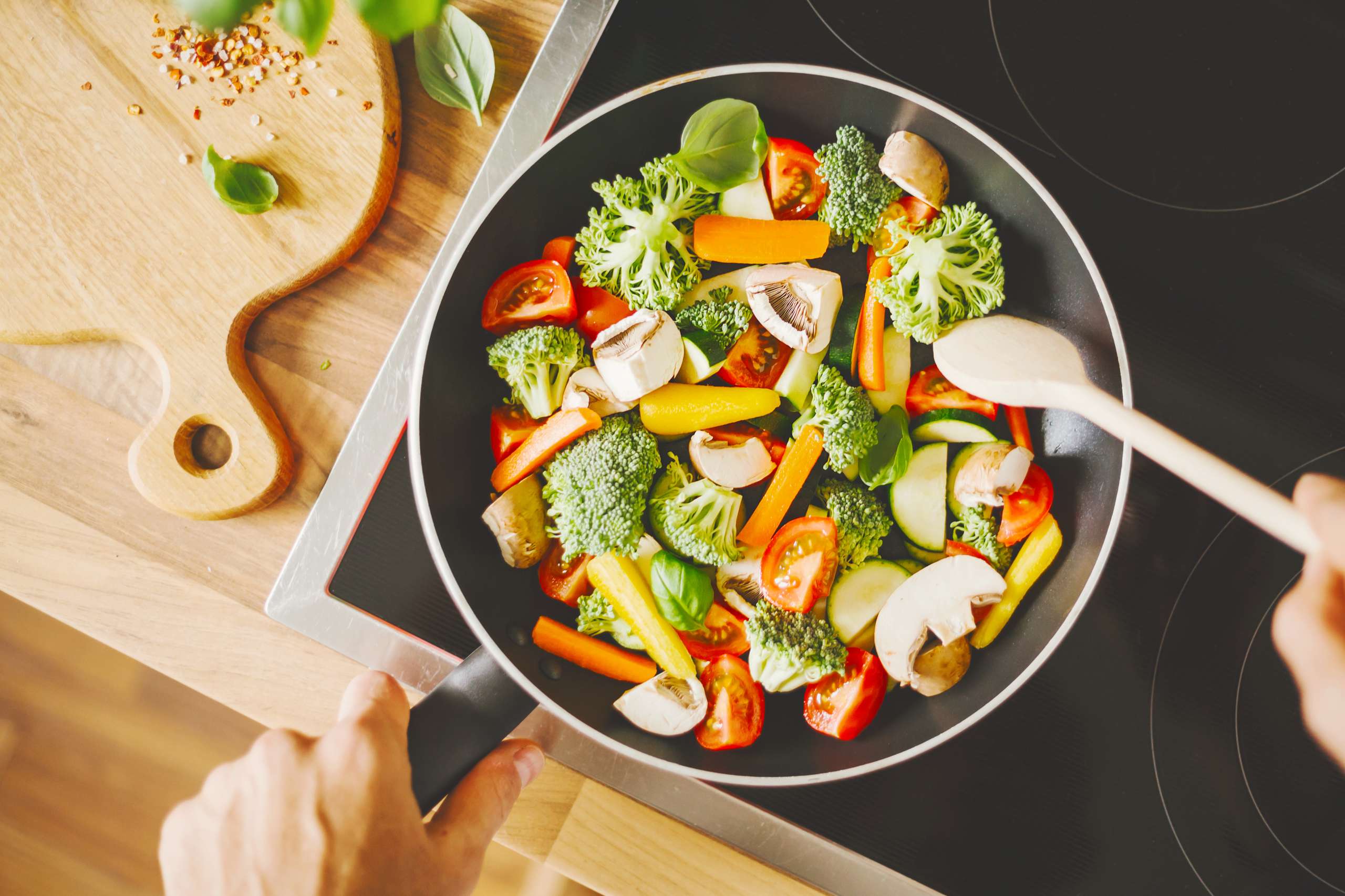Man cooking fresh vegetables in pan-  Protein Intake For Fertility