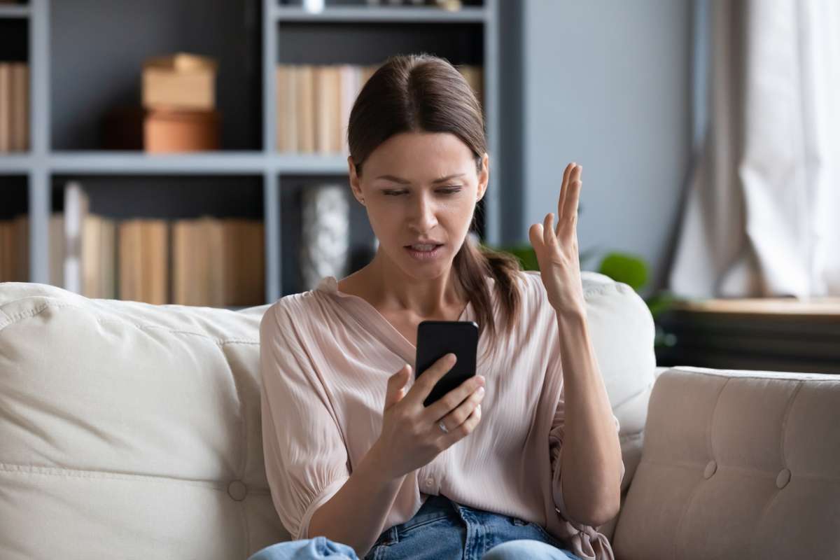 Confused angry young woman having problem with phone- Effects Of Social Media On Emotions
