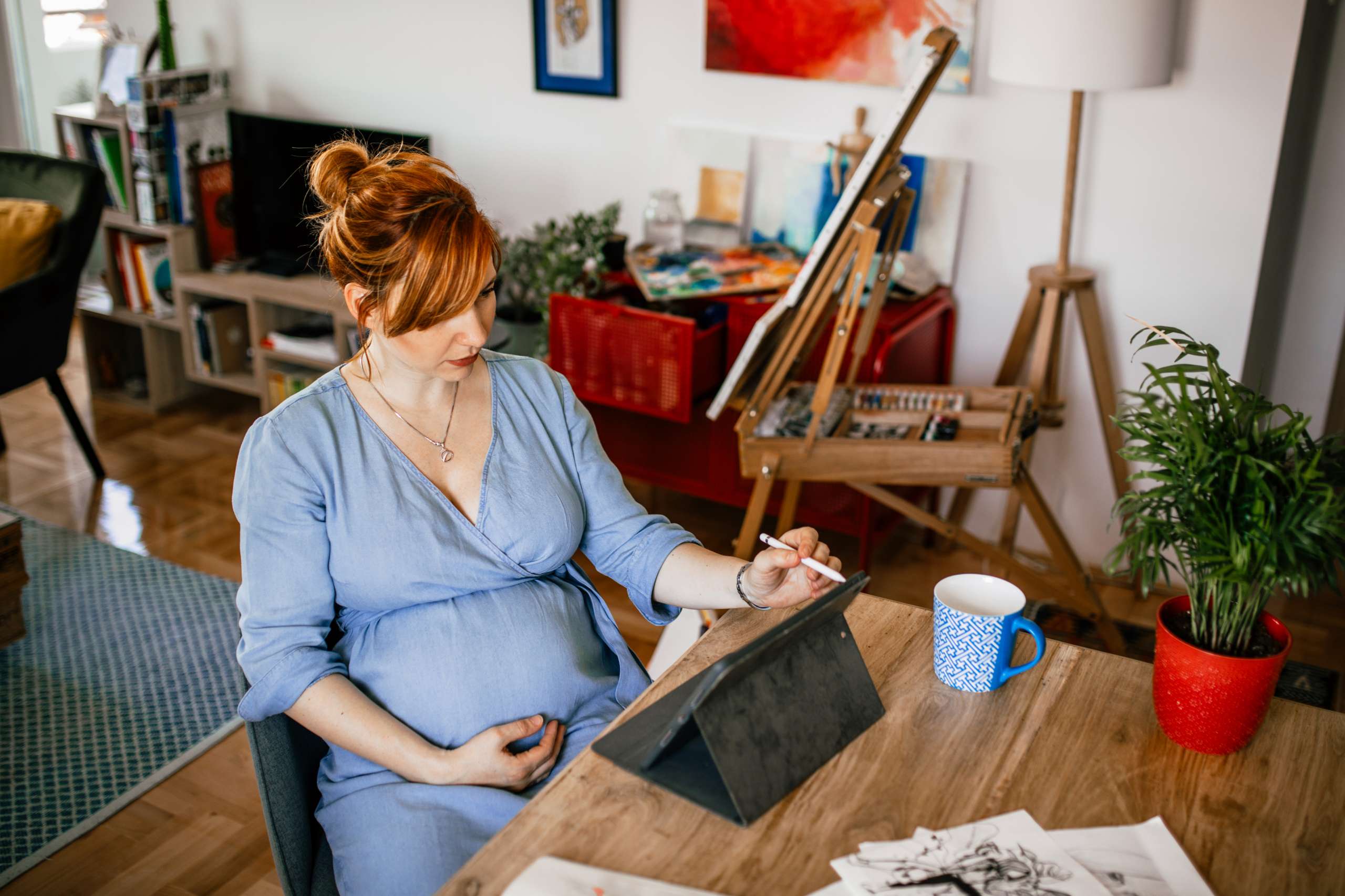 Woman artist doing artwork at home- Fertility and Art Therapy