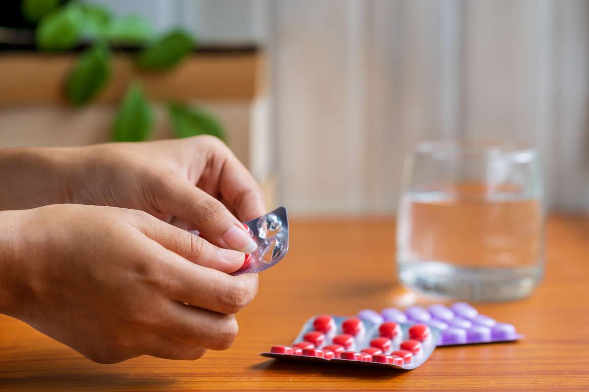Woman Taking Pills or Medicine-Pregnant woman with pills in hand