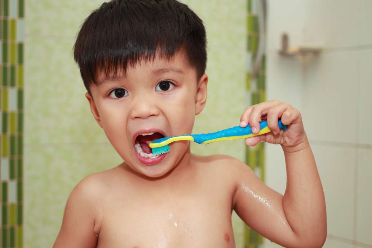 Boy brushing teeth.
