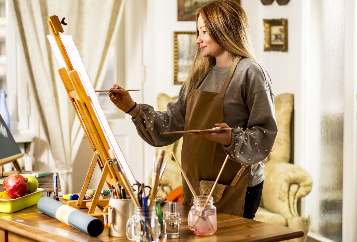 Young pregnant woman artist.