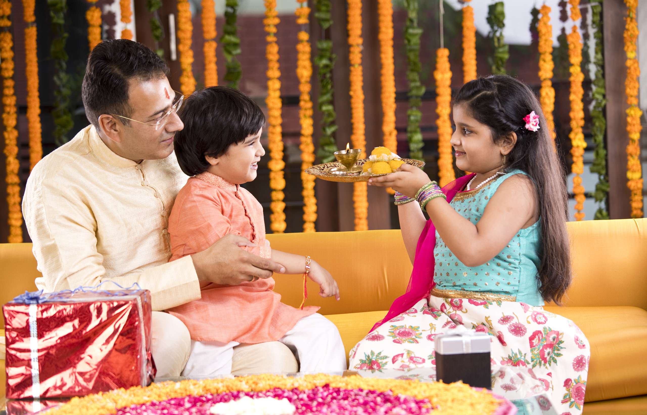 Indian family celebrating Raksha Bandhan- Family Traditions In Child's Identity Formation