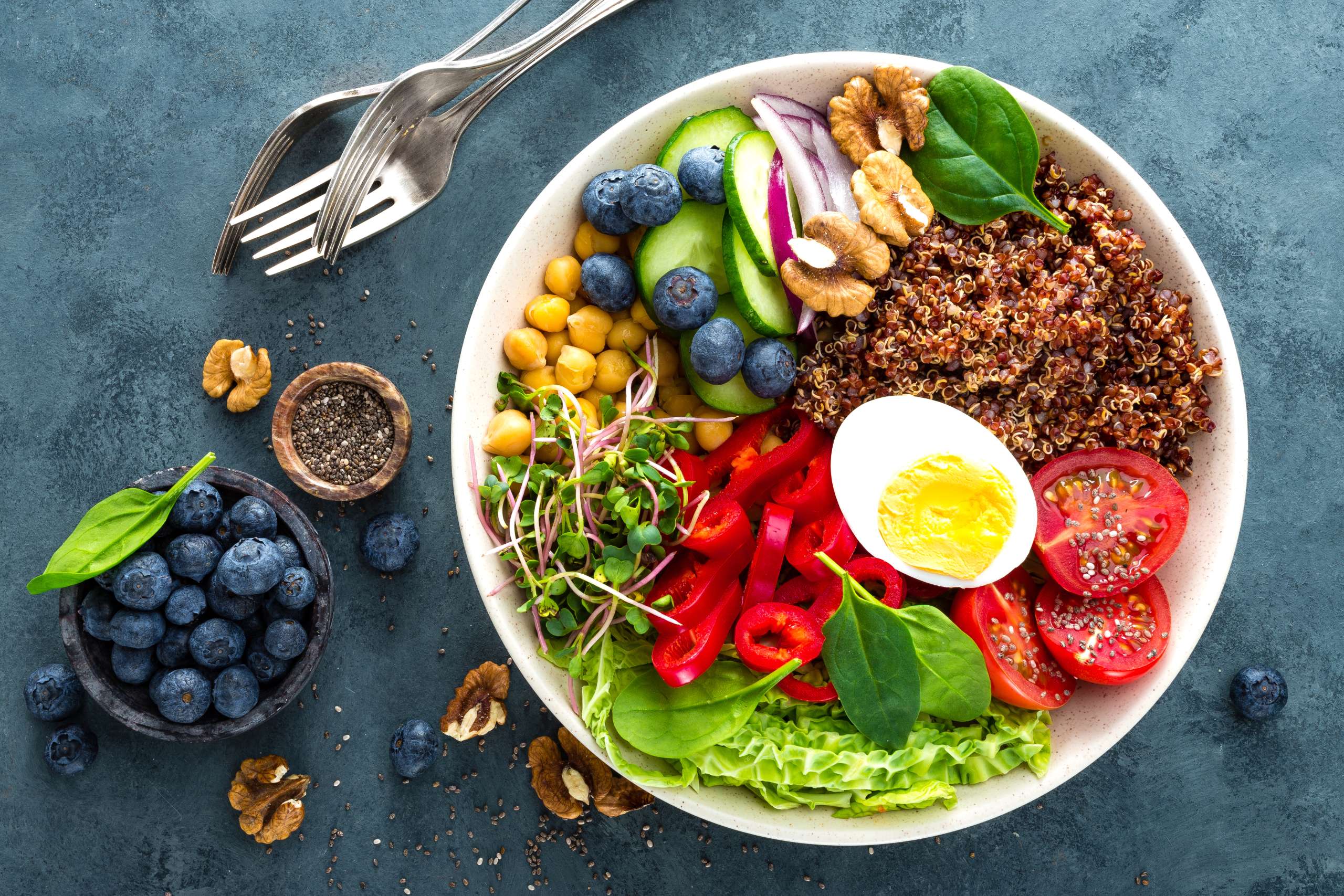 Buddha bowl dinner with boiled egg, chickpea, fresh tomato, sweet pepper, cucumber, savoy cabbage, red onion, green sprouts, spinach leaves, blueberry, walnuts, chia and quinoa. Healthy dish, lunch bowl. Detox diet. Balanced food- Holistic Therapies For Emotional Well-Being