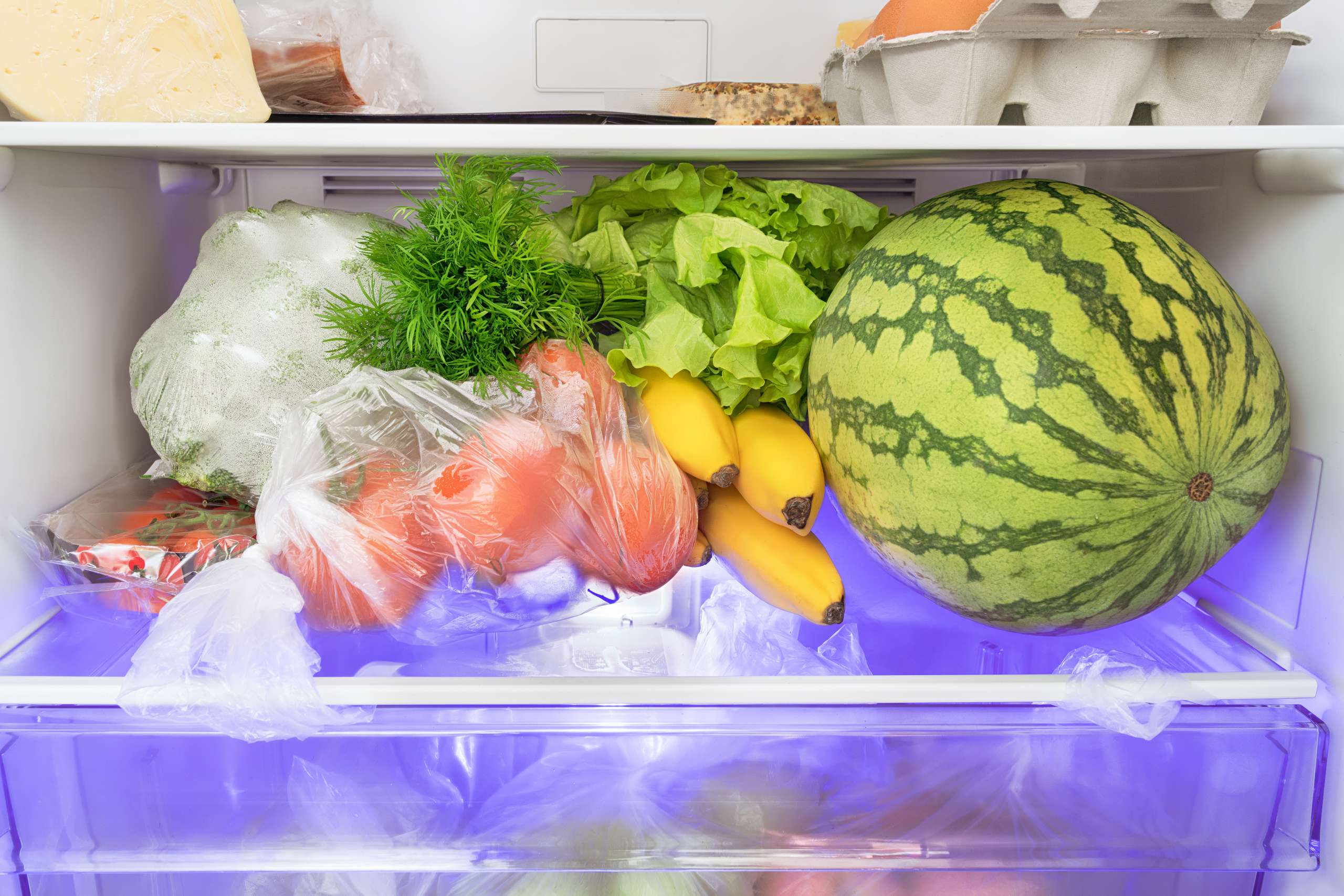 Fresh food into fridge. Fruits, vegetables, watermelon, cheese and eggs into cold store- Pregnancy After Breast Cancer