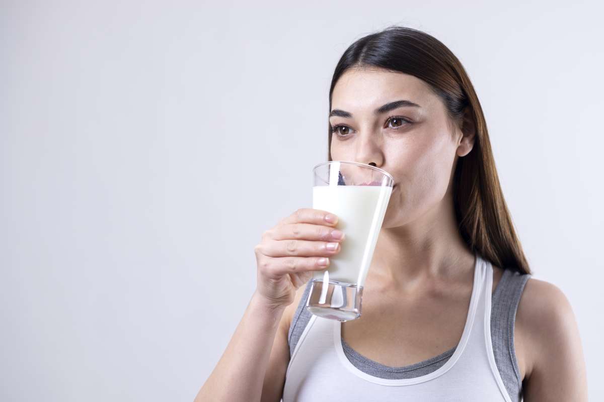 young woman drinking a glass of milk- Calcium For Optimal Reproductive Health